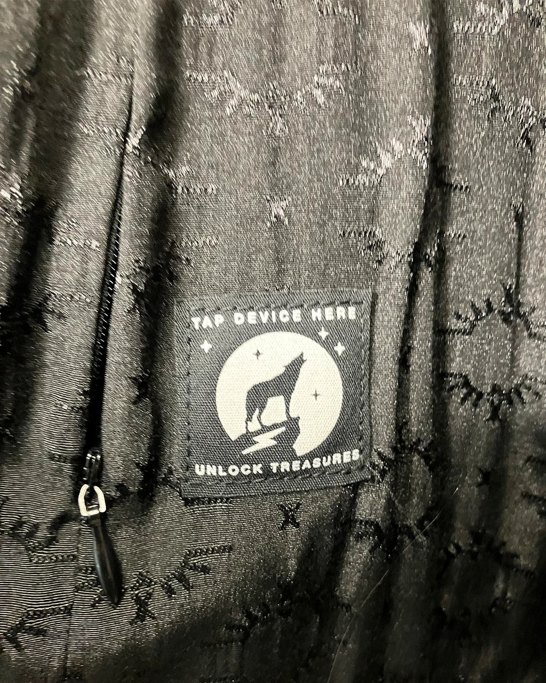 inner lining of the rosewood finch faux fur coat showing the SpiritHoods branded logo liner and inner secret zipper pocket