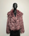 Mannequin wearing a pink and purple patterned faux fur jacket against a plain background