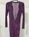 A long-sleeve purple leopard-print dress hanging on a black hanger against a plain white wall.