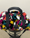 Colorful fur-patterned saddle pad on a black saddle