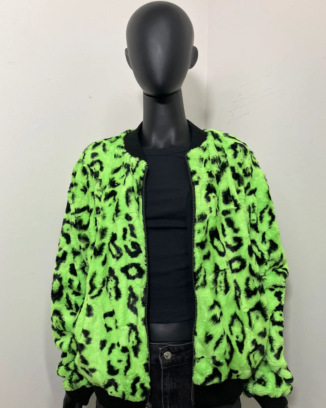 Mannequin wearing a neon green leopard print jacket against a plain background