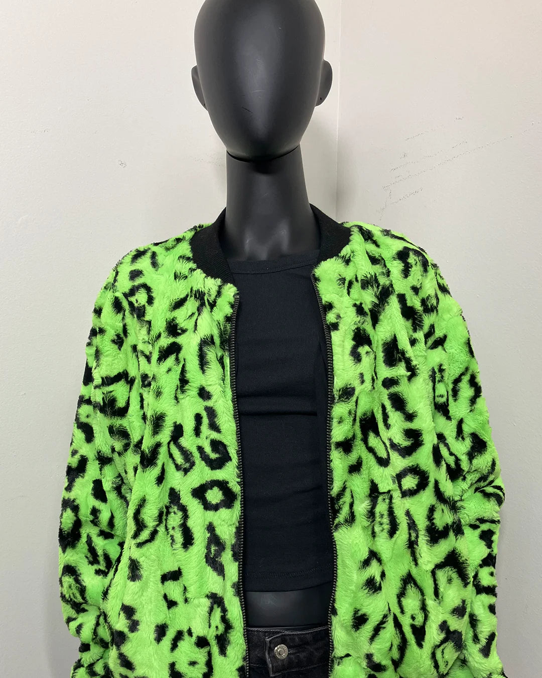 Mannequin wearing a neon green leopard print jacket against a plain background