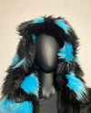 Mannequin wearing a black and blue fur-lined hood against a beige background