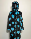 Black fur coat with blue heart patterns on a white background