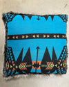 Decorative pillow with blue and black pattern on a neutral background