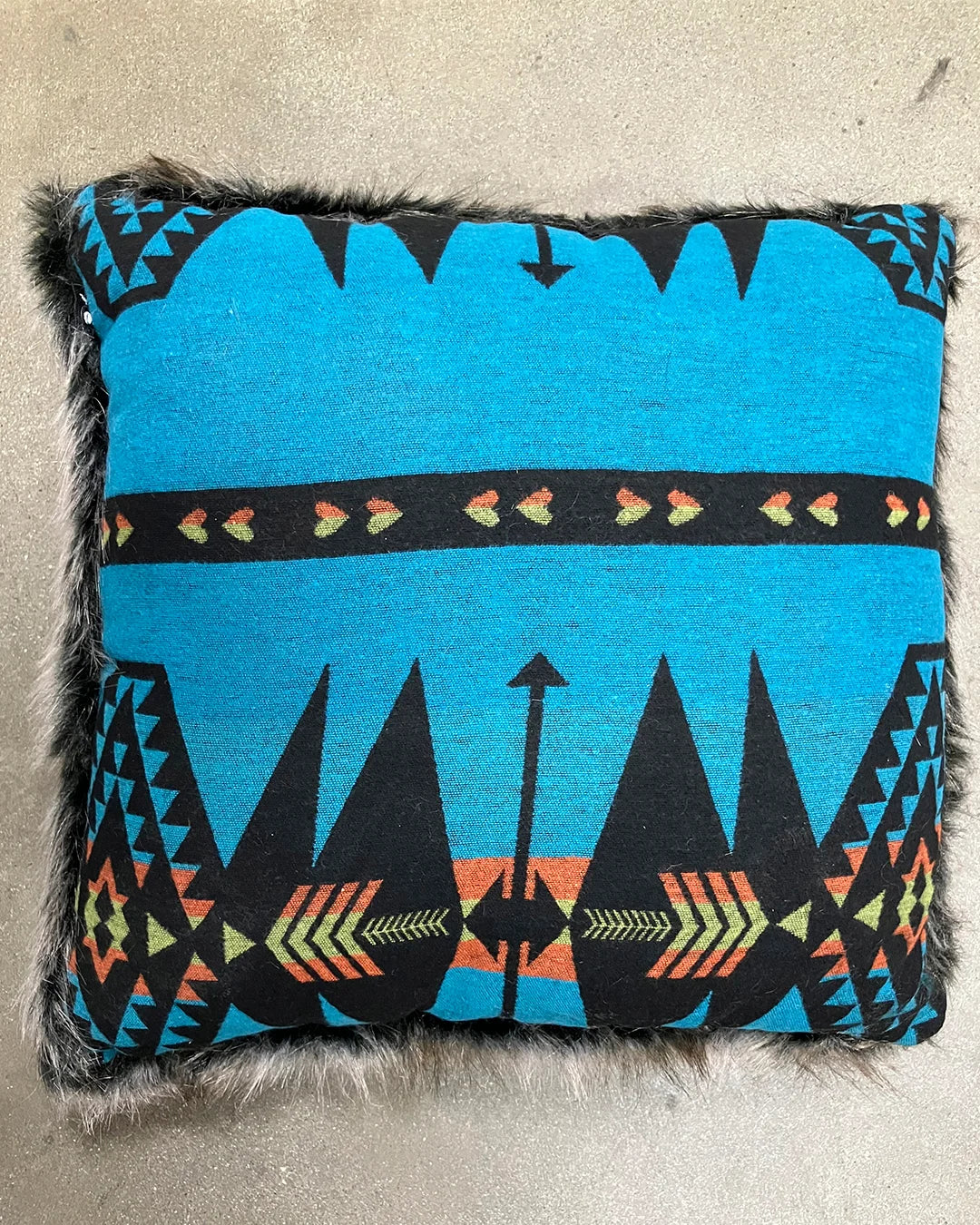 Decorative pillow with blue and black pattern on a neutral background