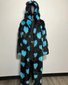 Mannequin wearing a black and blue polka dot fur coat against a plain background