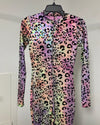 A long-sleeve zip-front bodysuit with an iridescent leopard print pattern, displayed on a black hanger against a plain light gray wall.