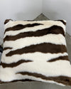 Zebra-striped pillow on a plain background