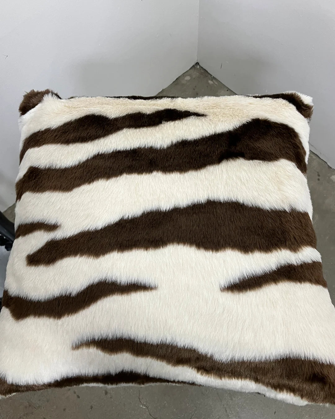 Zebra-striped pillow on a plain background