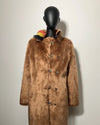 Brown faux fur coat on a mannequin against a plain background