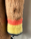 Close-up of a fur product with multicolored trim on a plain background