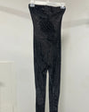 Black snakeskin-patterned strapless bodysuit hanging from a clear plastic hanger against a plain white wall.