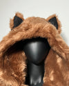 Brown furry hood with wolf ear accents on a mannequin head against a white background