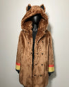 Brown faux fur coat with wolf ears on a mannequin against a light background
