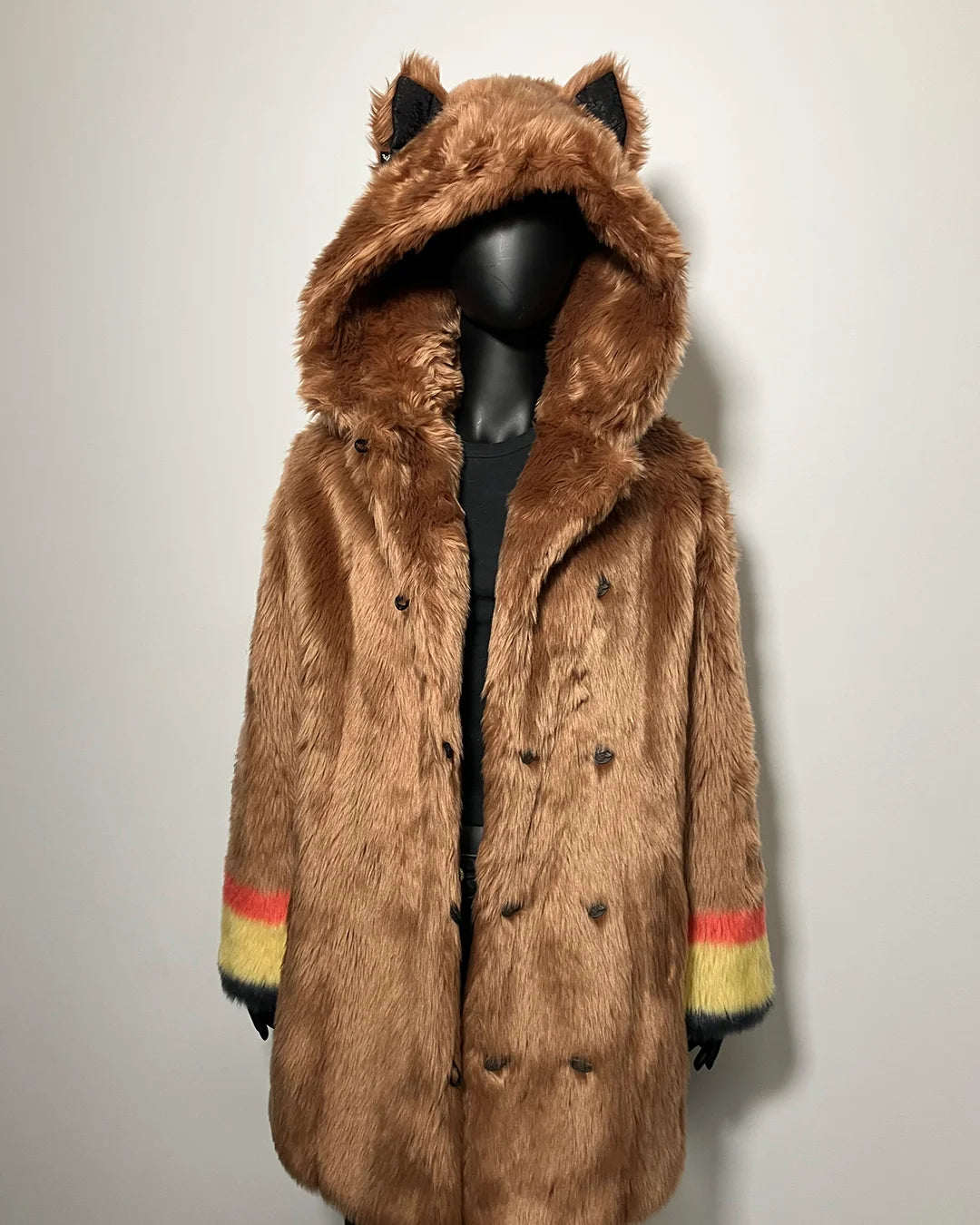 Brown faux fur coat with wolf ears on a mannequin against a light background
