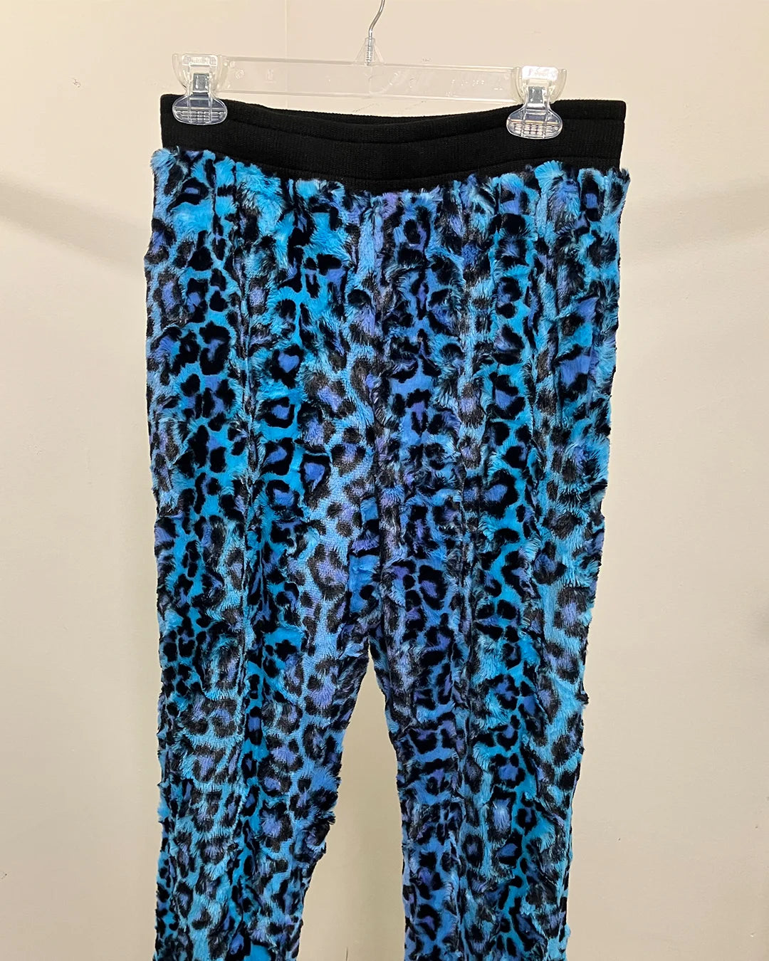Blue leopard print pants on a beige background