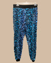 Blue leopard print pants on a beige background