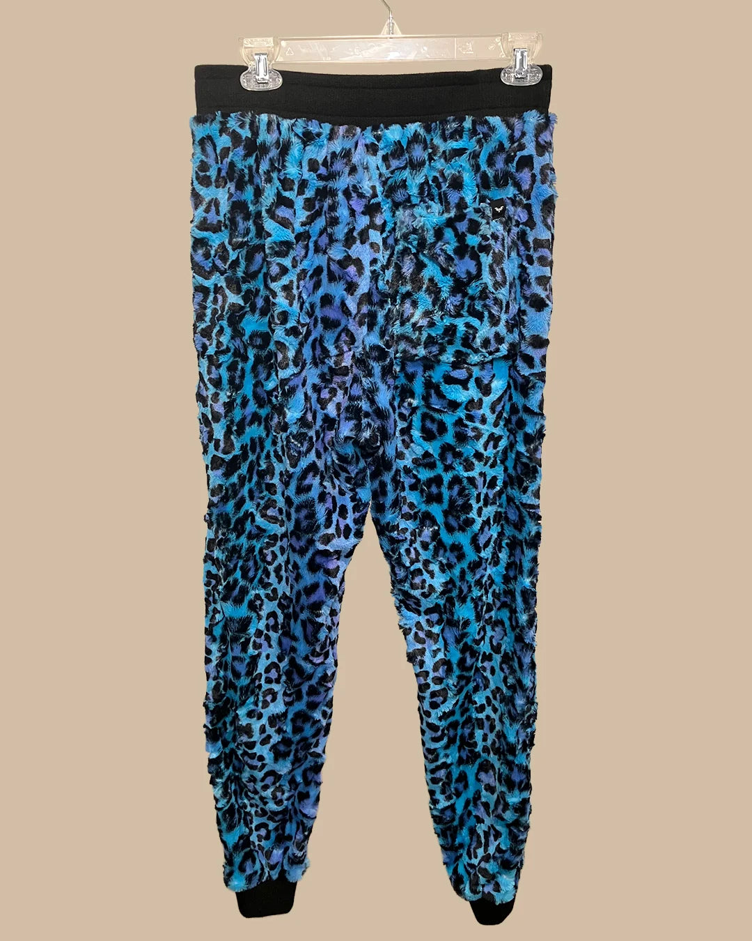 Blue leopard print pants on a beige background