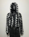 Mannequin wearing a black and white fur coat with a hood against a plain background