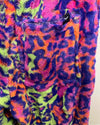 Close-up of a colorful, patterned leopard print sweatpant fabric with vibrant colors.