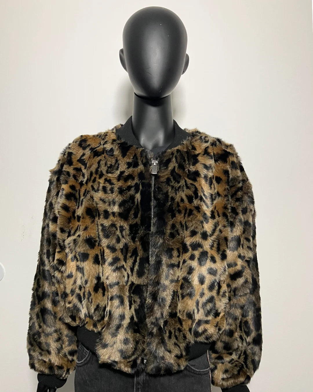 Leopard print jacket on a mannequin against a plain background