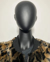 Mannequin wearing a leopard print jacket with a plain background