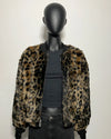 Mannequin wearing a leopard print jacket on a plain background