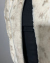 Close-up of a beige fur coat with a zipper on a gray background