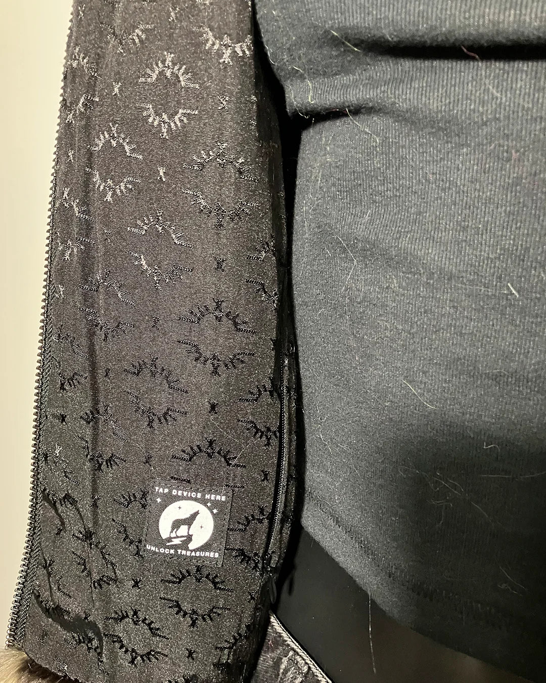 Close-up of the SpiritHoods logo liner in the Ocelot Faux Fur Bomber Jacket sample