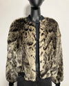 Leopard print fake fur coat on a mannequin against a white background