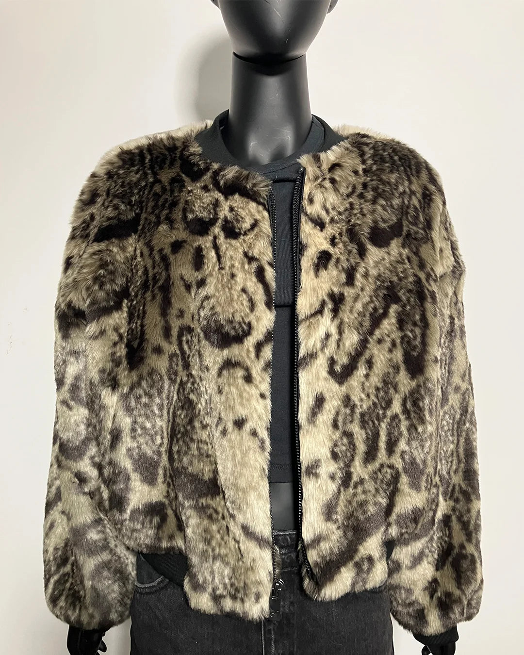 Leopard print fake fur coat on a mannequin against a white background