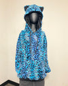 A blue leopard-print hooded sweatshirt with cat ears on the hood, displayed on a black mannequin against a plain beige wall.