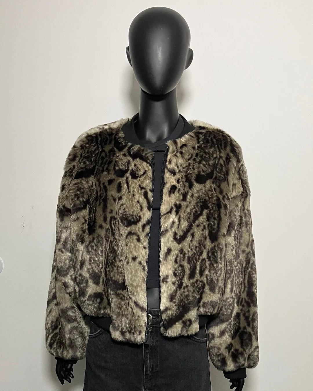 Leopard print faux fur jacket on a mannequin against a white background