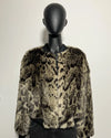 Leopard print fake fur jacket on a mannequin against a plain background