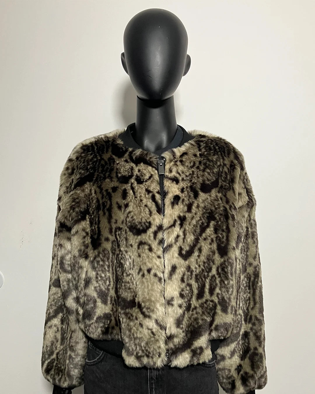 Leopard print fake fur jacket on a mannequin against a plain background