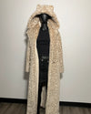 Leopard print coat on a mannequin against a plain background