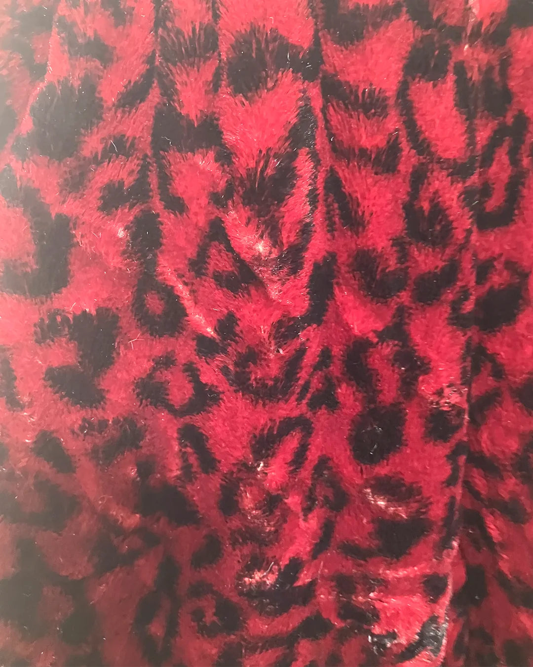 Red fabric with black leopard print pattern