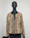 A leopard print faux fur jacket displayed on a black mannequin torso. The jacket features a beige and brown animal print pattern with black ribbed collar, cuffs, and hem, and a silver zipper closure.