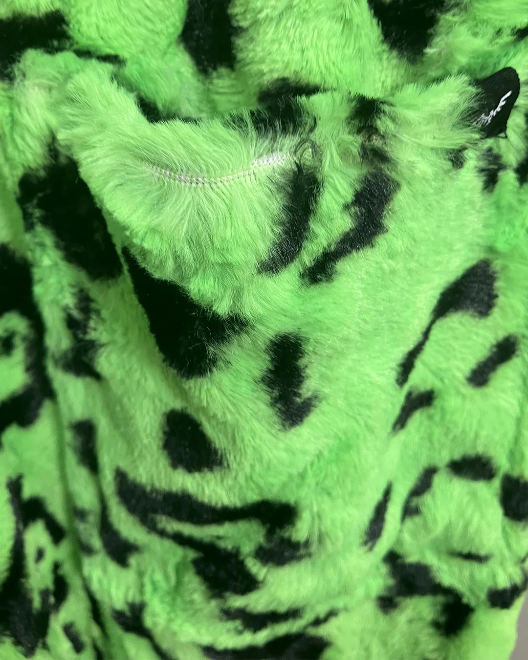 Close-up of green fabric with black leopard pattern