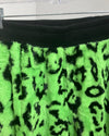 Green and black leopard print fabric on a hanger