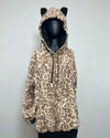 A leopard print hooded jacket with cat ears on the hood, displayed on a black mannequin against a plain light gray wall.