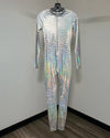 A full-body silver holographic jumpsuit with a front zipper and hood, hanging on a black hanger against a plain gray wall.