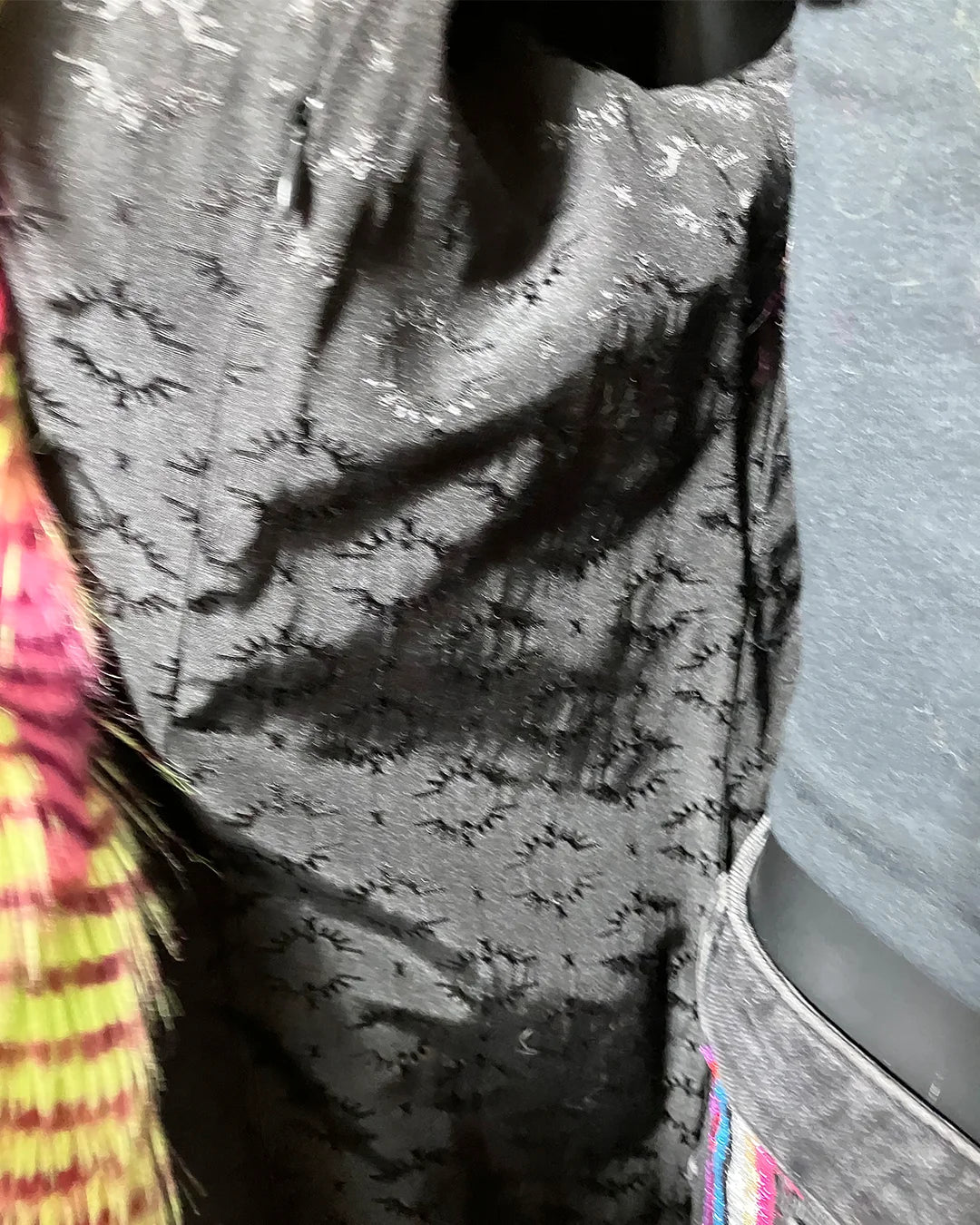 Close-up of a textured black SpiritHoods logo liner and inner zipper pocket
