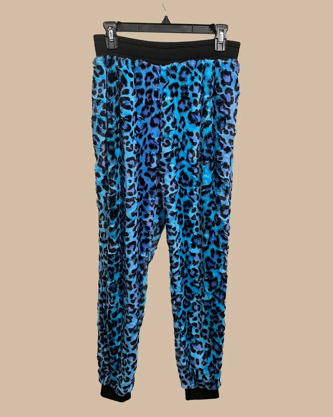 Blue leopard print lounge pants on a beige background