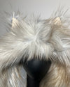 Close-up of a fluffy white hood on a mannequin against a neutral background