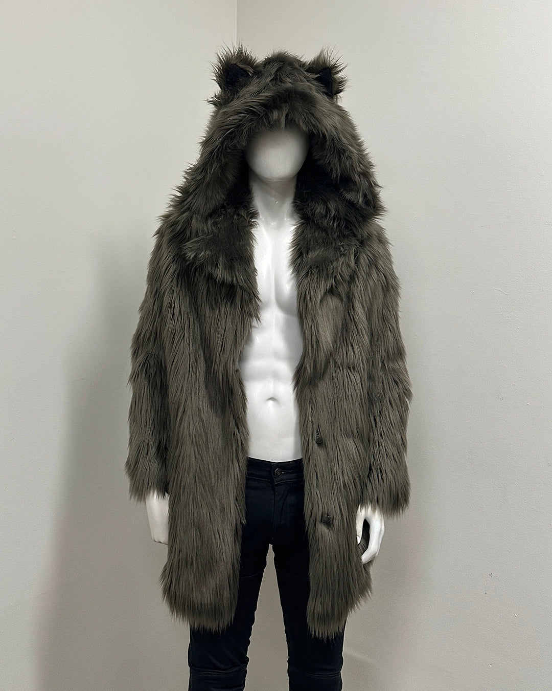 Mannequin wearing a long, dark fur coat with wolf ears on a plain background