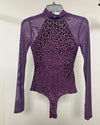 A purple long-sleeve bodysuit with a leopard print pattern on the torso and sheer mesh sleeves, hanging on a hanger against a plain light background.