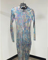 A long-sleeve, full-length one-piece jumpsuit with a high mock neck, covered in a shimmering iridescent holographic pattern of blue, purple, pink, and silver, displayed on a hanger against a plain white wall.