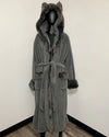 A gray plush hooded robe with faux-fur trim and ear-like details on the hood, displayed on a black mannequin against a plain white wall.